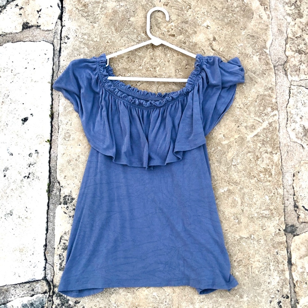 Off the shoulder blue flow shirt.